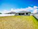 Spacious, green backyard enclosed by a white vinyl fence at 284 Talladega Ln, Polk City, FL 33868