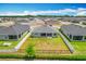 Well-maintained backyard featuring green grass, a fence, and a view of the neighborhood at 284 Talladega Ln, Polk City, FL 33868