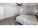 Large bedroom with carpet, ceiling fan, and ensuite bathroom at 284 Talladega Ln, Polk City, FL 33868