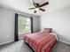 Cozy bedroom showcasing a comfortable bed, soft carpeting, and a window with serene outdoor views at 284 Talladega Ln, Polk City, FL 33868
