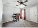 Comfortable bedroom with gray walls, plush carpeting, and a dedicated workstation for work or gaming at 284 Talladega Ln, Polk City, FL 33868