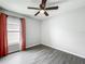 Bedroom with luxury vinyl plank flooring, a ceiling fan, and neutral colored walls at 284 Talladega Ln, Polk City, FL 33868