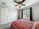 Bright bedroom featuring neutral paint, soft carpeting, and a window with pleasant backyard views at 284 Talladega Ln, Polk City, FL 33868