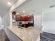 Open kitchen with granite countertops, stainless steel appliances, and dark wood cabinets at 284 Talladega Ln, Polk City, FL 33868