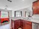 Spacious kitchen featuring granite countertops, stainless steel dishwasher, and wood cabinets at 284 Talladega Ln, Polk City, FL 33868