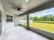 Spacious screened lanai with ceiling fan overlooking the backyard at 284 Talladega Ln, Polk City, FL 33868
