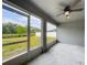 The screened lanai provides an outdoor view of the lush backyard at 284 Talladega Ln, Polk City, FL 33868