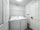 Laundry room with washer, dryer and overhead storage at 284 Talladega Ln, Polk City, FL 33868