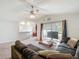 Open living room with gray carpet, neutral walls, fan, and a sliding glass door at 284 Talladega Ln, Polk City, FL 33868