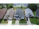Aerial view of the homes showcasing their well-maintained lawns and proximity to the lake at 2889 Blooming Alamanda Loop, Kissimmee, FL 34747
