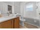 Bathroom with marble countertop, updated vanity, a bathtub with shower, and neutral colors at 2889 Blooming Alamanda Loop, Kissimmee, FL 34747