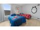 bedroom with Mickey Mouse themed decor, twin beds, and natural light from the window at 2889 Blooming Alamanda Loop, Kissimmee, FL 34747
