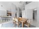 Open-concept dining room with high ceilings, view of staircase, and modern chandelier above the table at 2889 Blooming Alamanda Loop, Kissimmee, FL 34747