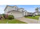 Charming two-story home with a spacious driveway and well-kept lawn and landscaping at 2889 Blooming Alamanda Loop, Kissimmee, FL 34747