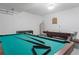 Spacious game room featuring a pool table, foosball table and air hockey for Gathering fun at 2889 Blooming Alamanda Loop, Kissimmee, FL 34747