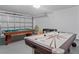 Game room with pool table, air hockey table, and foosball table in spacious area with garage door at 2889 Blooming Alamanda Loop, Kissimmee, FL 34747