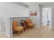 Hallway featuring two chairs, wooden floors, a glass side table, and a picture on the wall at 2889 Blooming Alamanda Loop, Kissimmee, FL 34747
