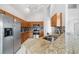 Modern kitchen featuring granite counters, stainless steel appliances, and ample cabinet space at 2889 Blooming Alamanda Loop, Kissimmee, FL 34747