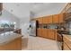 Well-equipped kitchen with granite countertops, stainless steel appliances, and wooden cabinets at 2889 Blooming Alamanda Loop, Kissimmee, FL 34747