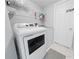 Functional laundry room with modern washer and dryer, ample storage, and clean white finish at 2889 Blooming Alamanda Loop, Kissimmee, FL 34747