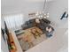 Bright living room featuring a gray sectional, a colorful rug, and stylish modern lighting fixture at 2889 Blooming Alamanda Loop, Kissimmee, FL 34747