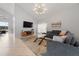 Stylish living room with a large sectional, modern lighting, and serene lake views at 2889 Blooming Alamanda Loop, Kissimmee, FL 34747