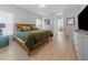 Cozy main bedroom featuring a wooden bed frame and access to the en-suite bathroom at 2889 Blooming Alamanda Loop, Kissimmee, FL 34747