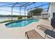 Inviting screened-in pool area with a lake view perfect for relaxing and entertaining guests at 2889 Blooming Alamanda Loop, Kissimmee, FL 34747