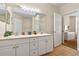 Well-lit bathroom featuring double sink vanity, a mirror, and a walk-in shower at 2952 Lucayan Harbour Cir # 106, Kissimmee, FL 34746