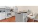Modern kitchen with white appliances, bar seating, and sleek countertops at 2952 Lucayan Harbour Cir # 106, Kissimmee, FL 34746