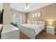 Bright bedroom featuring a queen-size bed, stylish decor, and natural light at 2952 Lucayan Harbour Cir # 106, Kissimmee, FL 34746
