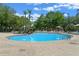 Beautiful community pool surrounded by lush landscaping and comfortable lounge chairs at 2952 Lucayan Harbour Cir # 106, Kissimmee, FL 34746