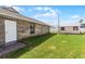 Well-maintained backyard with lush green grass, storage shed, and easy access to home at 30 Capistrano Dr, Ormond Beach, FL 32176