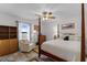 Comfortable bedroom featuring a four-poster bed, ceiling fan, and ample natural light at 30 Capistrano Dr, Ormond Beach, FL 32176