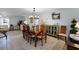 Open dining space featuring a chandelier, a dining table, decorative furniture, and wood look floors at 30 Capistrano Dr, Ormond Beach, FL 32176