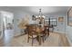 Dining room with a chandelier, dining table, and a view of a bright window, with views into other rooms at 30 Capistrano Dr, Ormond Beach, FL 32176