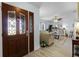 Inviting entryway with decorative glass doors that leads into the spacious, naturally lit living room at 30 Capistrano Dr, Ormond Beach, FL 32176