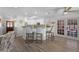 Open kitchen with granite counters, bar stool seating, stainless appliances, and french doors to the patio at 30 Capistrano Dr, Ormond Beach, FL 32176