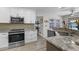 Well-appointed kitchen with stainless steel appliances, granite countertops, and mosaic backsplash at 30 Capistrano Dr, Ormond Beach, FL 32176