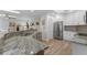 Bright kitchen featuring stainless steel appliances, granite countertops, and ample cabinet space at 30 Capistrano Dr, Ormond Beach, FL 32176