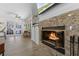 Inviting living room with a granite fireplace, open floorplan, and sliding doors to the outdoor space at 30 Capistrano Dr, Ormond Beach, FL 32176