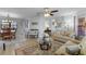 Comfortable living area with couches, a ceiling fan, a glass table, and views into other rooms at 30 Capistrano Dr, Ormond Beach, FL 32176