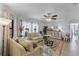 Bright living room with a large window, light-colored couches, stylish decor, and wood look floors at 30 Capistrano Dr, Ormond Beach, FL 32176