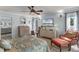Bright and airy main bedroom featuring a ceiling fan, sitting area, and ensuite bathroom access at 30 Capistrano Dr, Ormond Beach, FL 32176