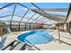 Sparkling enclosed pool with lounge chairs and outdoor dining area for relaxation at 30 Capistrano Dr, Ormond Beach, FL 32176