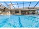 Sparkling in-ground pool enclosed with a screened cage, perfect for relaxation and recreation at 30 Capistrano Dr, Ormond Beach, FL 32176