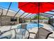 Enclosed backyard pool area with a screened enclosure and comfortable outdoor seating at 30 Capistrano Dr, Ormond Beach, FL 32176