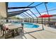 Enclosed pool area featuring blue water, lounge chairs, and an outdoor dining set at 30 Capistrano Dr, Ormond Beach, FL 32176