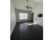 Bright bedroom with a ceiling fan, dark floors, natural light, and vaulted ceilings at 3337 Soho St # 205, Orlando, FL 32835