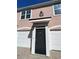 Charming townhome entrance with a black front door and attached one-car garage at 3337 Soho St # 205, Orlando, FL 32835